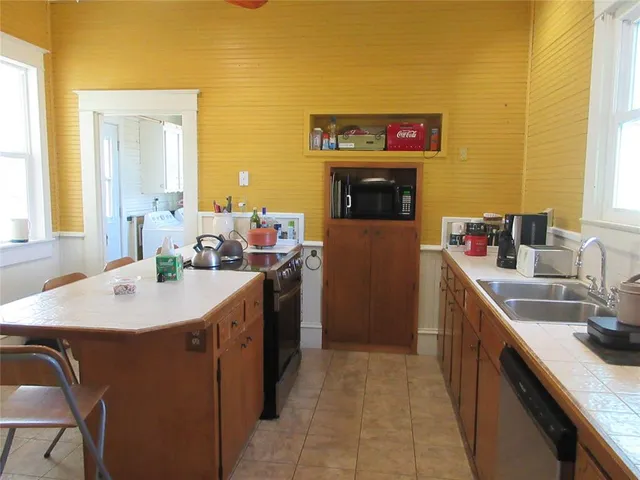 a kitchen with a sink stove and refrigerator