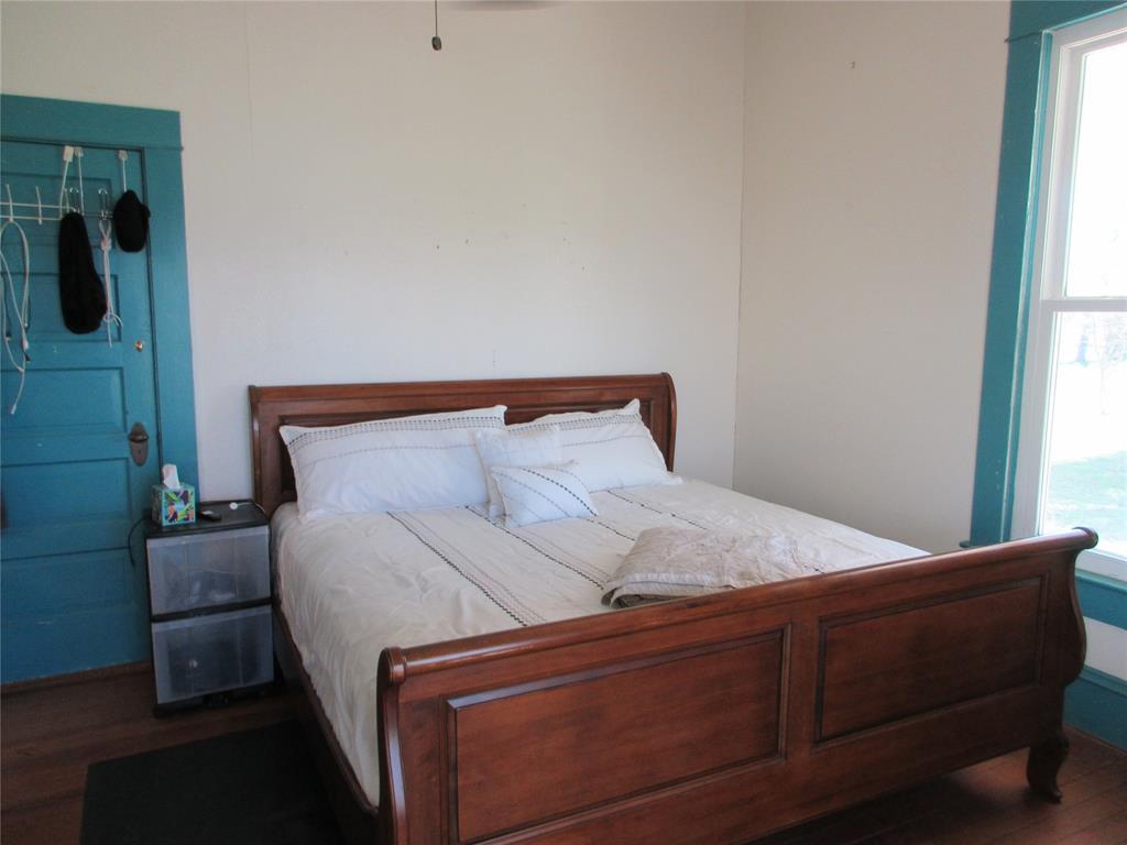 607 1st Street Rosebud, TX 76570 - Photo 16 of 29 a bed sitting in a bedroom next to a window