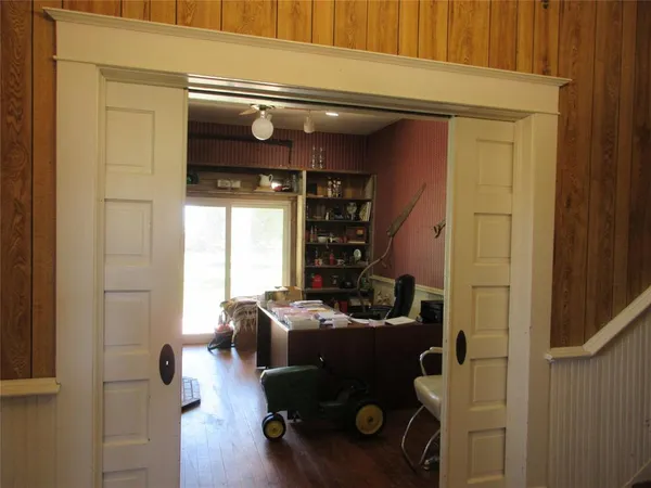 a view of entryway with workspace and windows