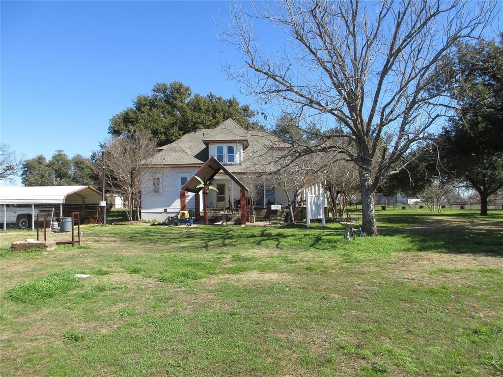 607 1st Street Rosebud, TX 76570 - Photo 2 of 29 a front view of a house with a yard