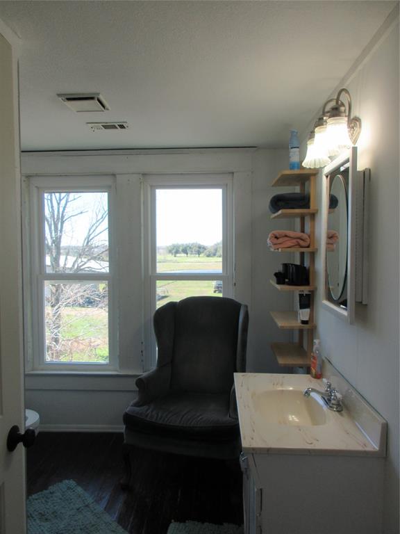 607 1st Street Rosebud, TX 76570 - Photo 25 of 29 a bathroom with a sink and a mirror