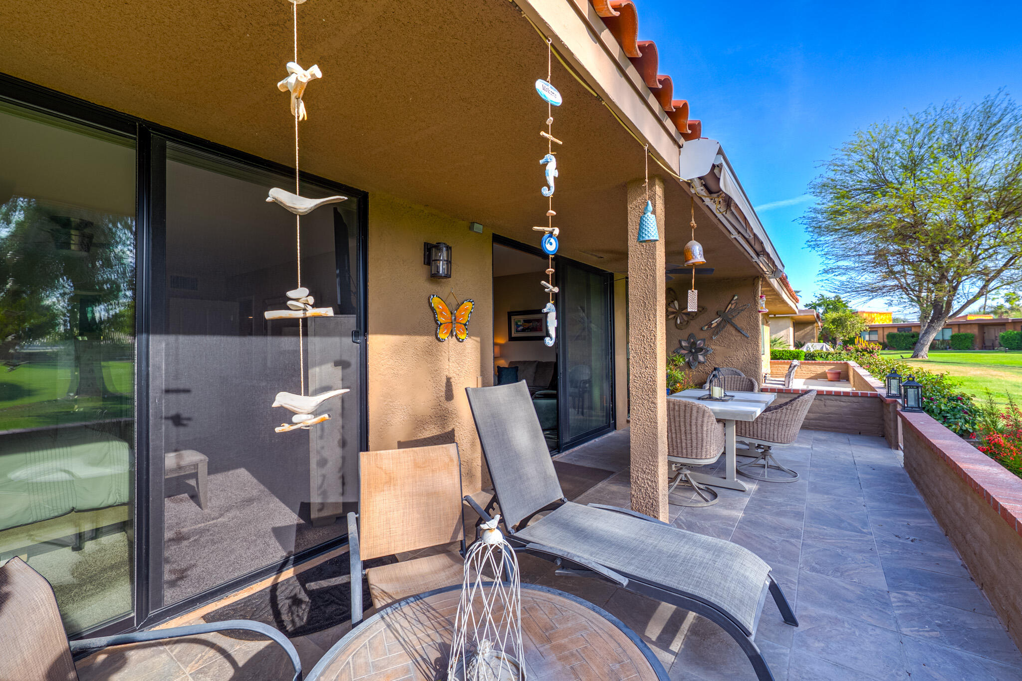 6 Sunrise Drive Rancho Mirage, CA 92270 - Photo 28 of 48 a view of a patio with dining table and chairs with wooden floor and fence