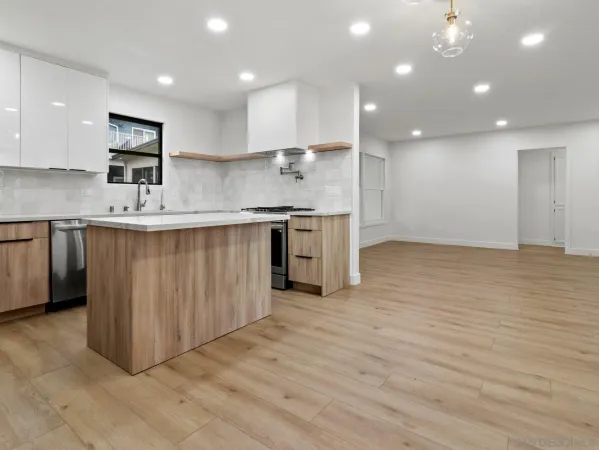 a kitchen with stainless steel appliances granite countertop a sink stove and cabinets