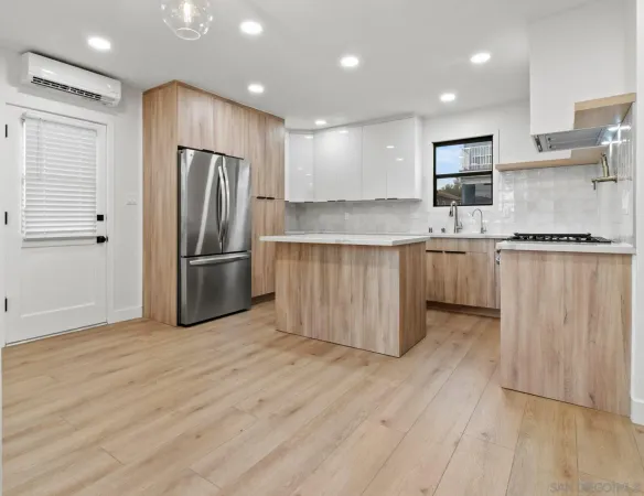 a kitchen with stainless steel appliances granite countertop a refrigerator and a stove top oven