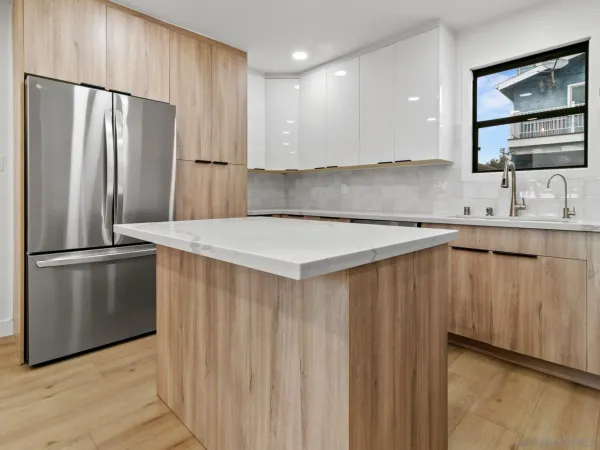 a kitchen with stainless steel appliances a refrigerator sink and cabinets