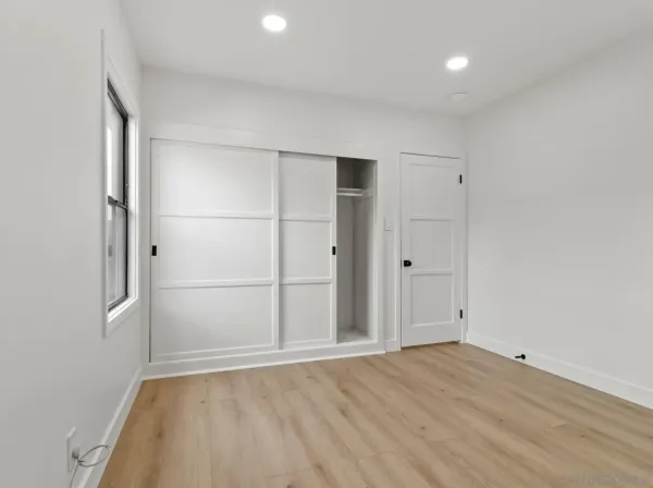 an empty room with wooden floor