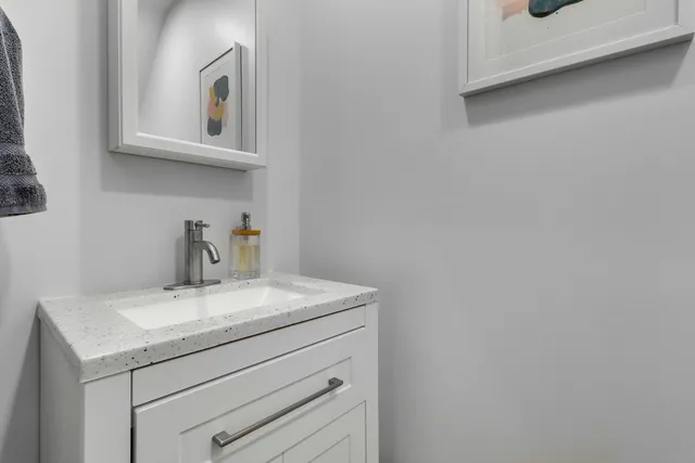 a bathroom with a sink a vanity and mirror