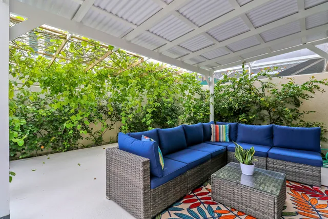 a view of outdoor sitting area with furniture and a garden