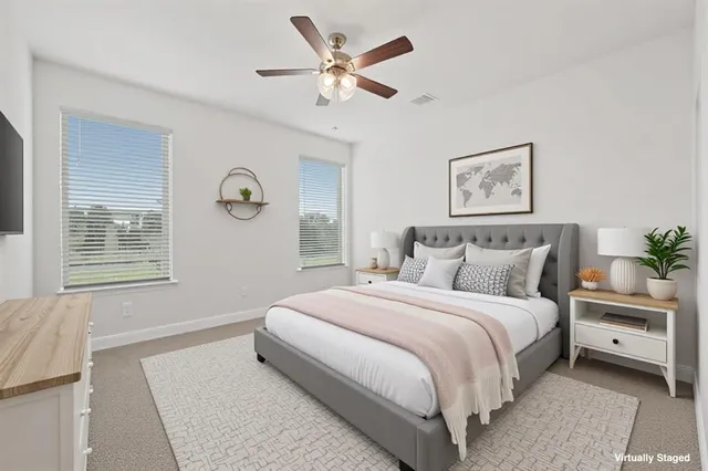 a bedroom with a large bed and a window