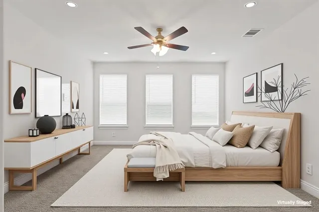 a bedroom with a bed couch and window