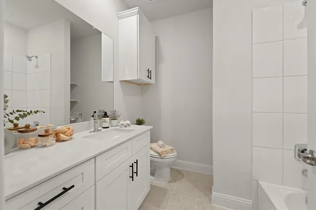 a bathroom with a sink toilet and vanity