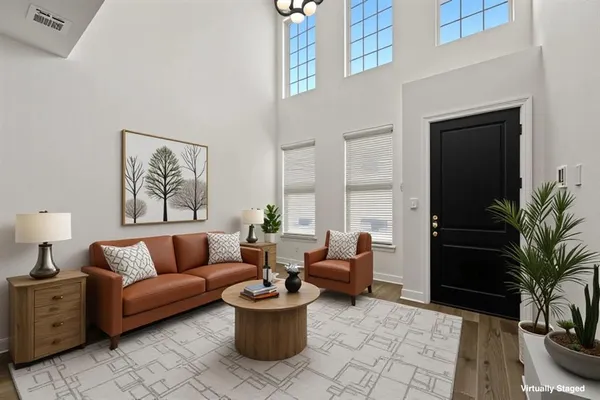 a living room with furniture potted plant and a window