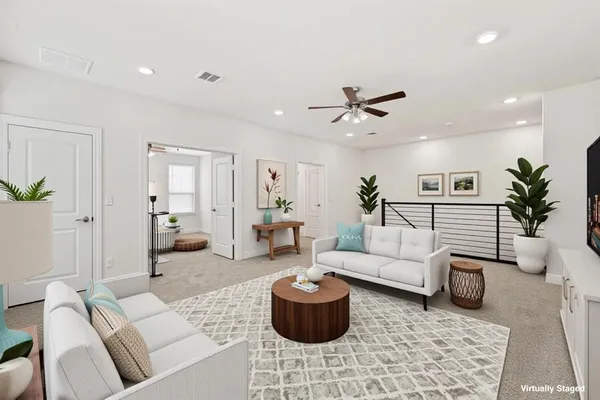 a living room with furniture and a chandelier