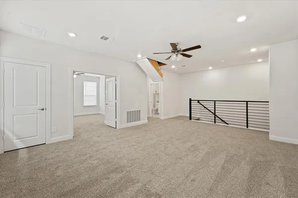 en view of a livingroom with a ceiling fan