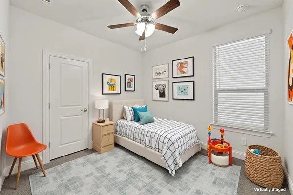 a bedroom with a bed and workspace