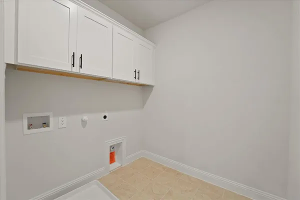 a view of storage and utility room with two washing machine