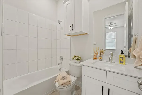 a bathroom with a sink a toilet and bathtub