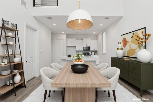 a kitchen with dining table and chairs