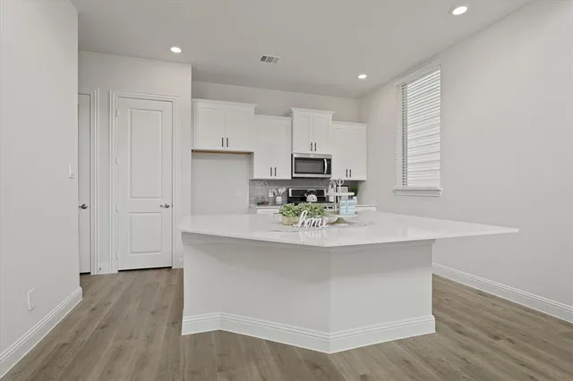 a view of kitchen with sink and refrigerator