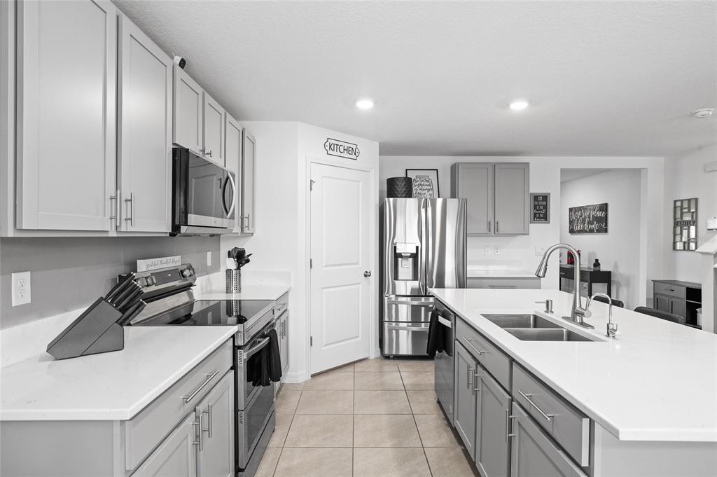 16507 Windmill Forge Pass Wimauma, FL 33598 - Photo 12 of 48 a kitchen with a sink stove and refrigerator