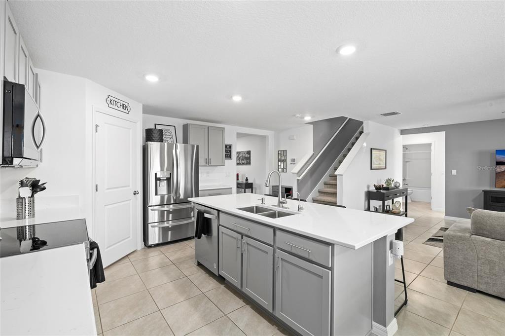 16507 Windmill Forge Pass Wimauma, FL 33598 - Photo 2 of 48 a kitchen that has a sink a refrigerator and a stove