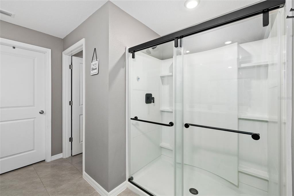 16507 Windmill Forge Pass Wimauma, FL 33598 - Photo 22 of 48 a bathroom with a glass door shower
