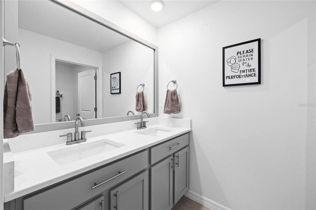 16507 Windmill Forge Pass Wimauma, FL 33598 - Photo 26 of 48 a bathroom with a sink and a mirror