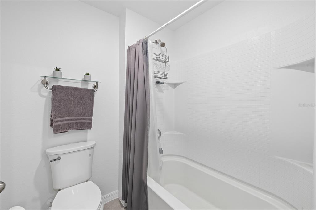 16507 Windmill Forge Pass Wimauma, FL 33598 - Photo 27 of 48 a bathroom with a toilet and a bathtub