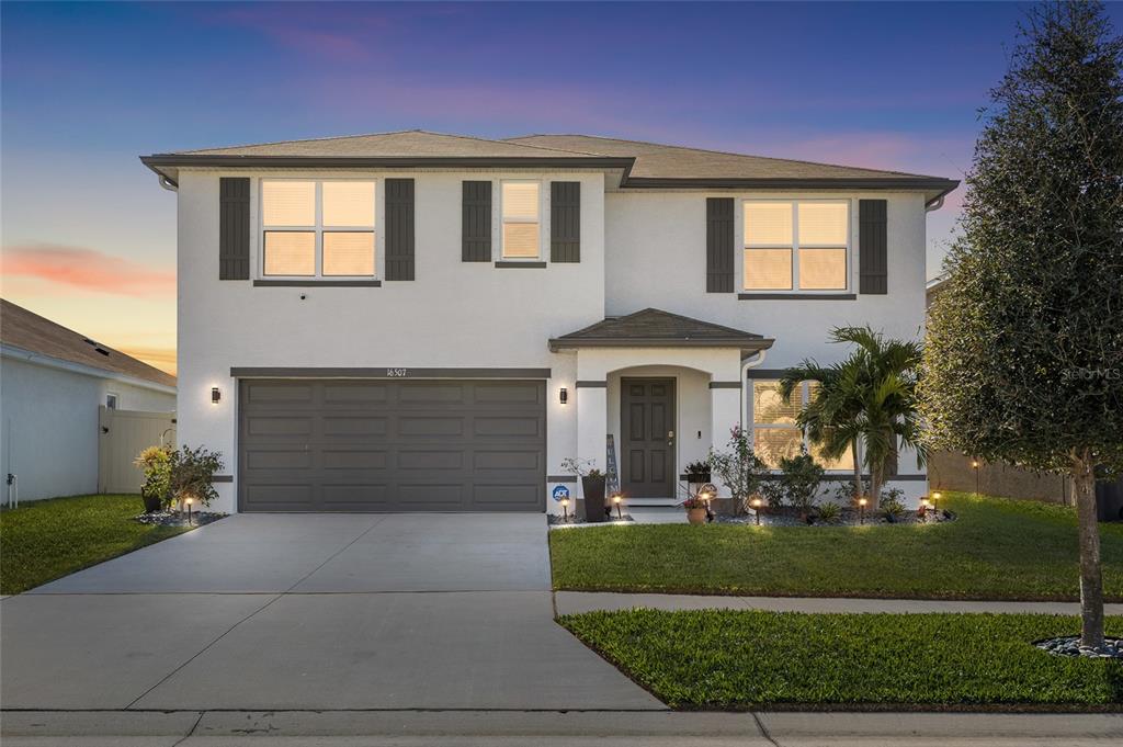 16507 Windmill Forge Pass Wimauma, FL 33598 - Photo 48 of 48 a front view of a house with garden