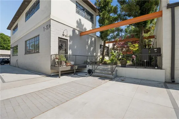 a backyard of a house with a yard and outdoor seating