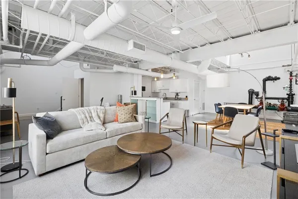 a living room with lots of furniture and a chandelier