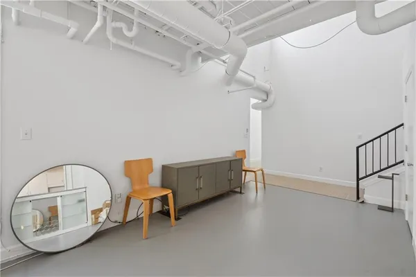 a living room with lots of furniture and kitchen view