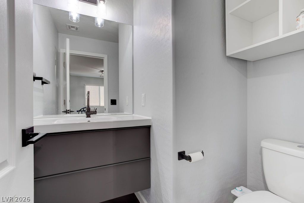 7724 Vibrant Thread Court Las Vegas, NV 89149 - Photo 19 of 43 A well-appointed bathroom featuring a contemporary vanity and a spacious mirror.