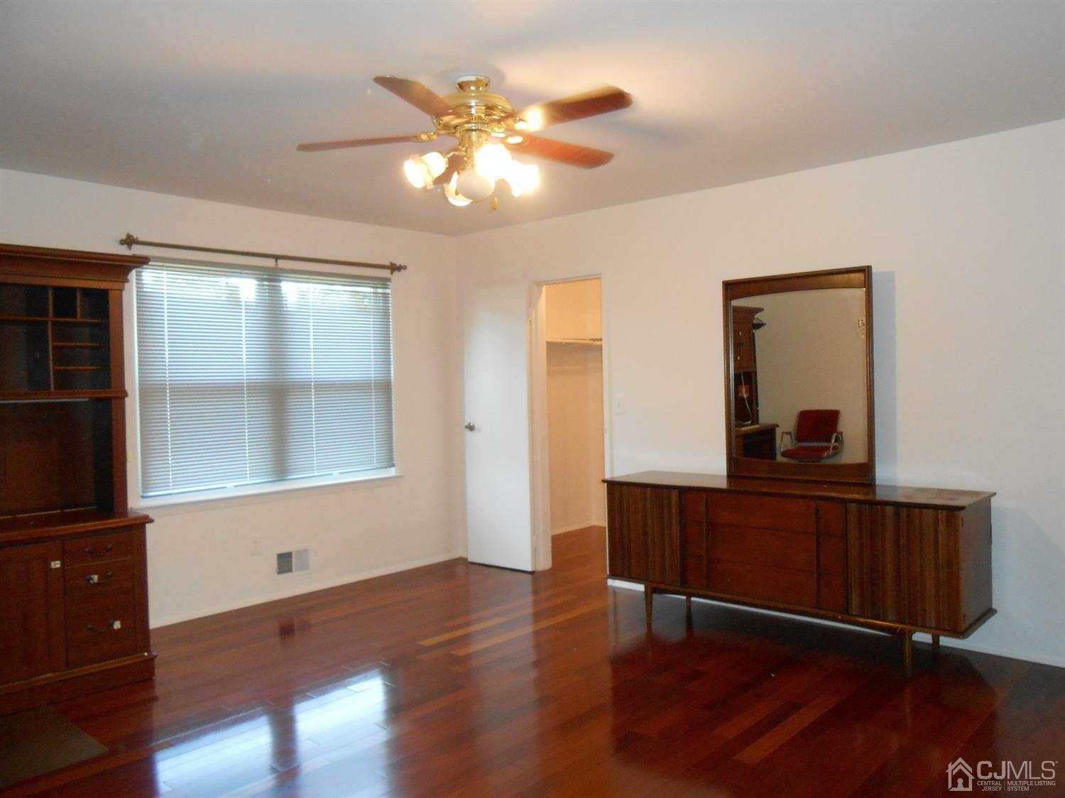 7206 Hana Road Edison, NJ 08817 - Photo 11 of 26 a living room with wooden floor and large window