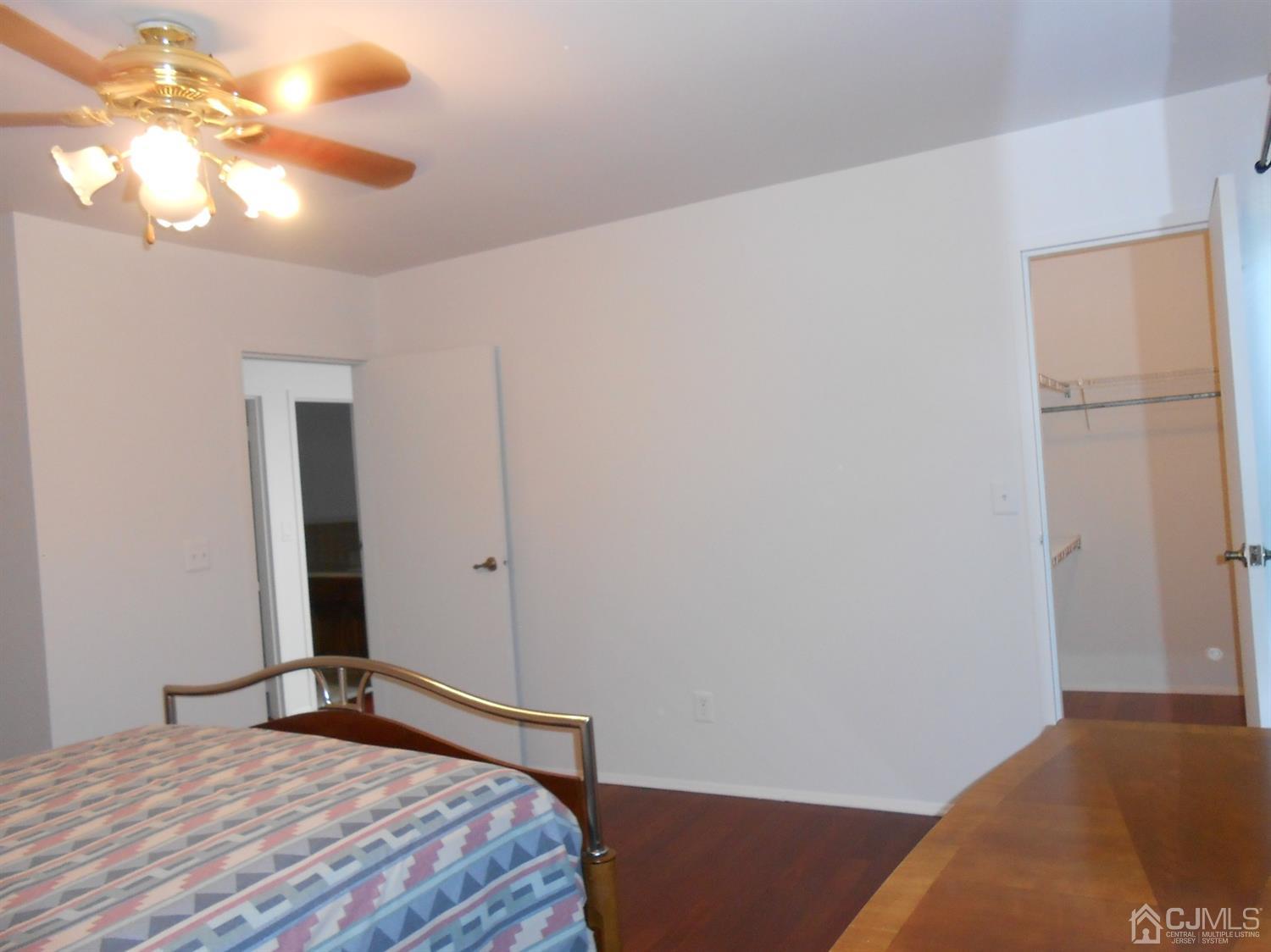 7206 Hana Road Edison, NJ 08817 - Photo 13 of 26 a bedroom with a bed and a chandelier