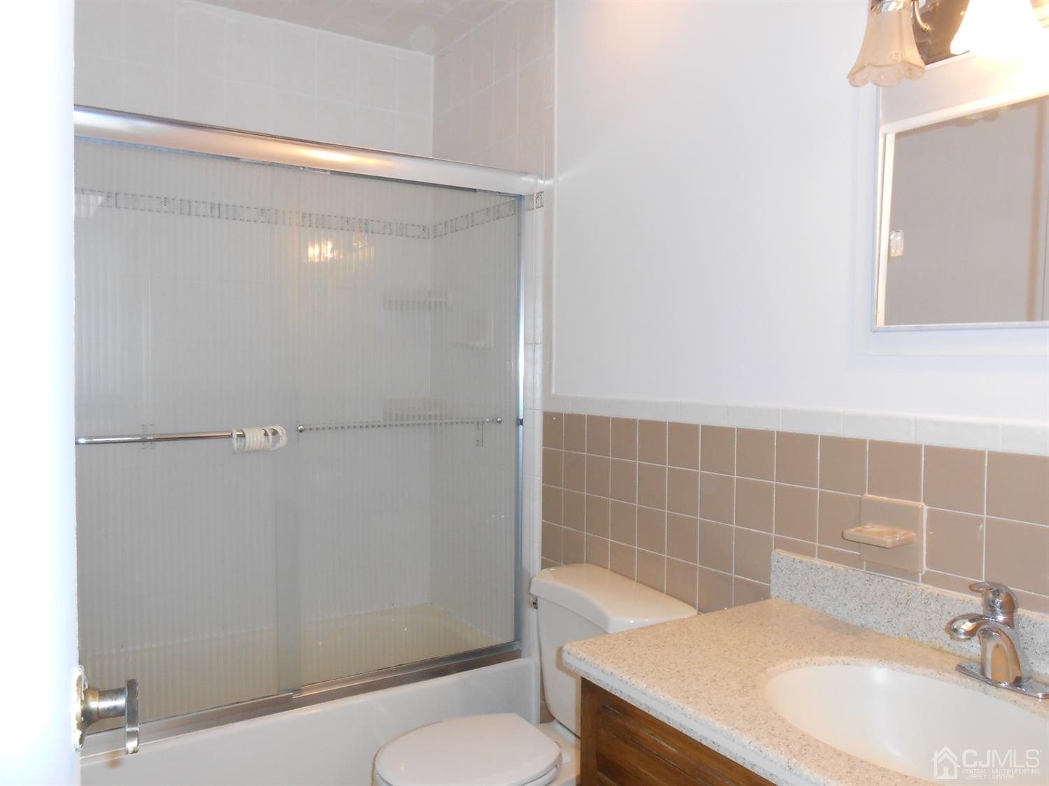 7206 Hana Road Edison, NJ 08817 - Photo 15 of 26 a bathroom with a sink a toilet and shower