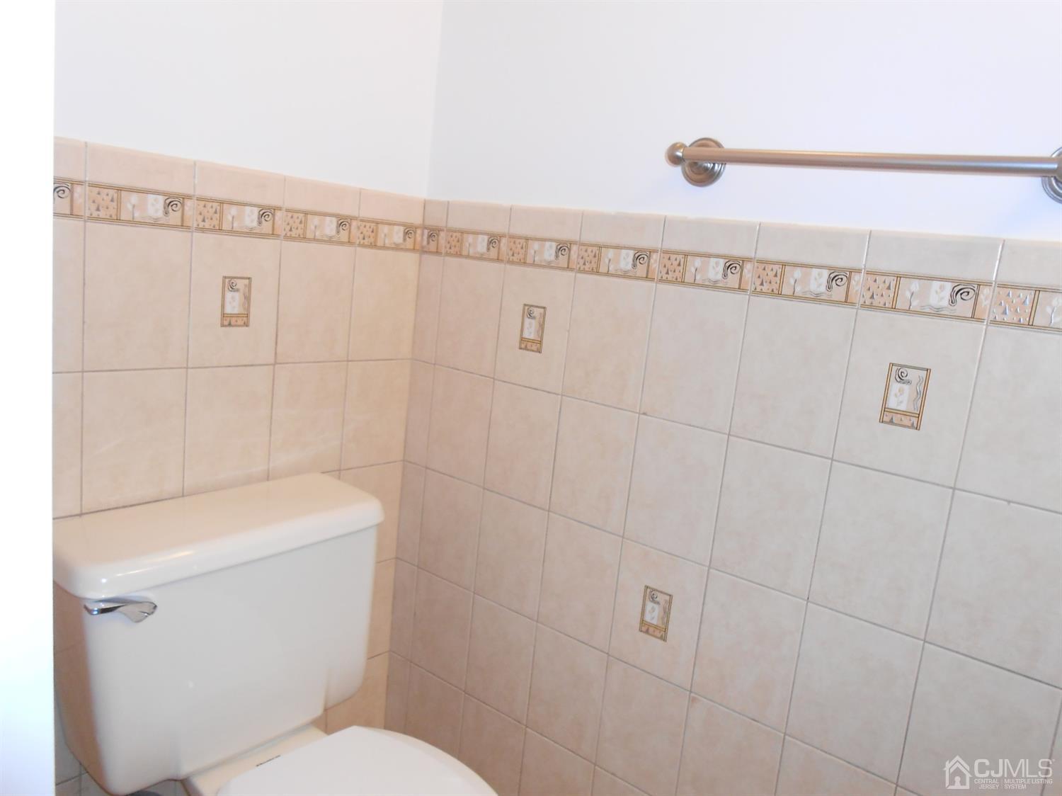 7206 Hana Road Edison, NJ 08817 - Photo 16 of 26 a bathroom with a toilet a sink and a shower