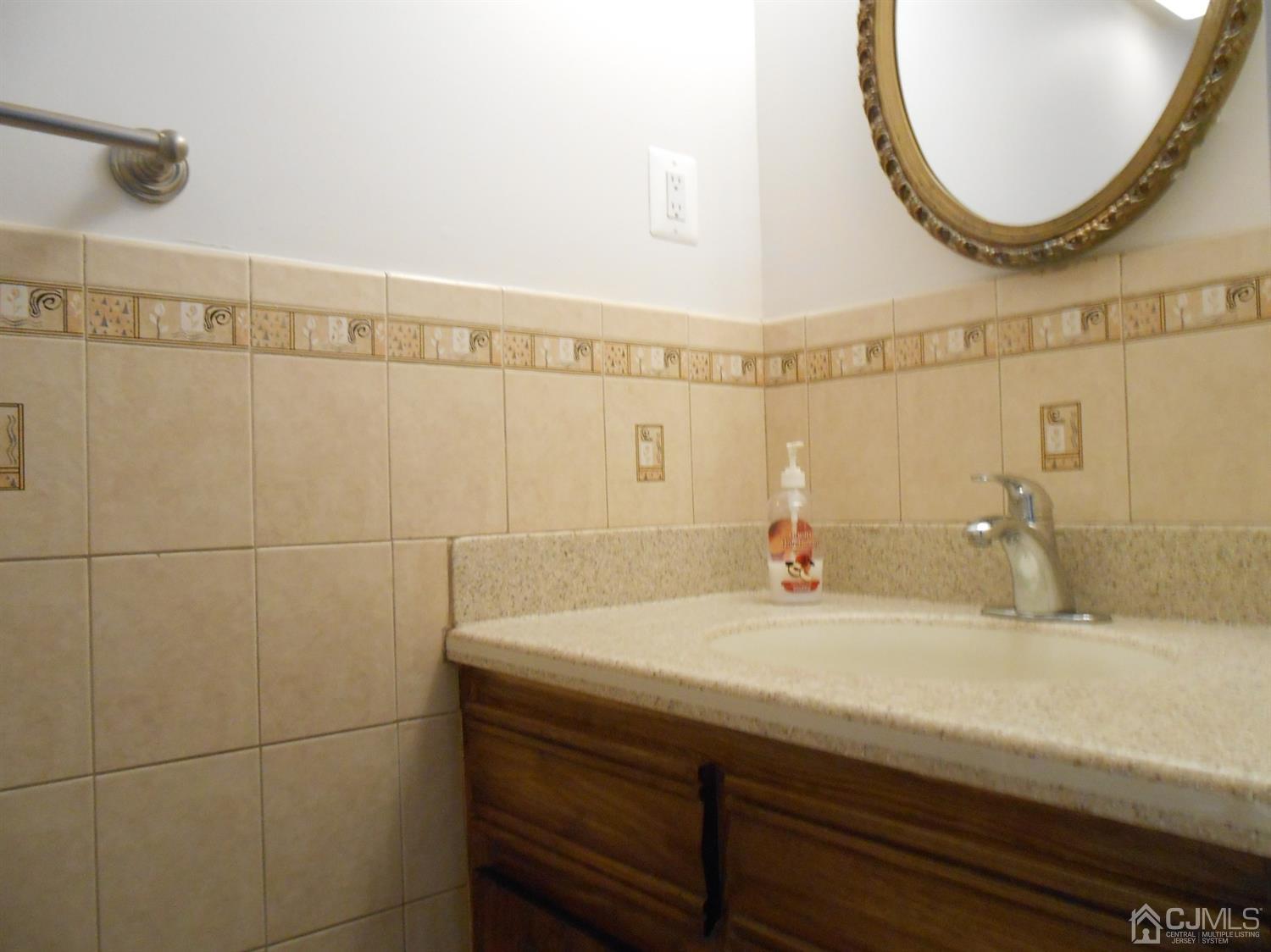 7206 Hana Road Edison, NJ 08817 - Photo 17 of 26 a bathroom with a sink and a mirror