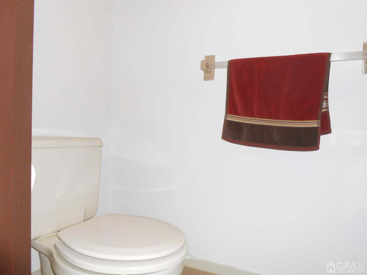7206 Hana Road Edison, NJ 08817 - Photo 19 of 26 a bathroom with a toilet and a shower curtain