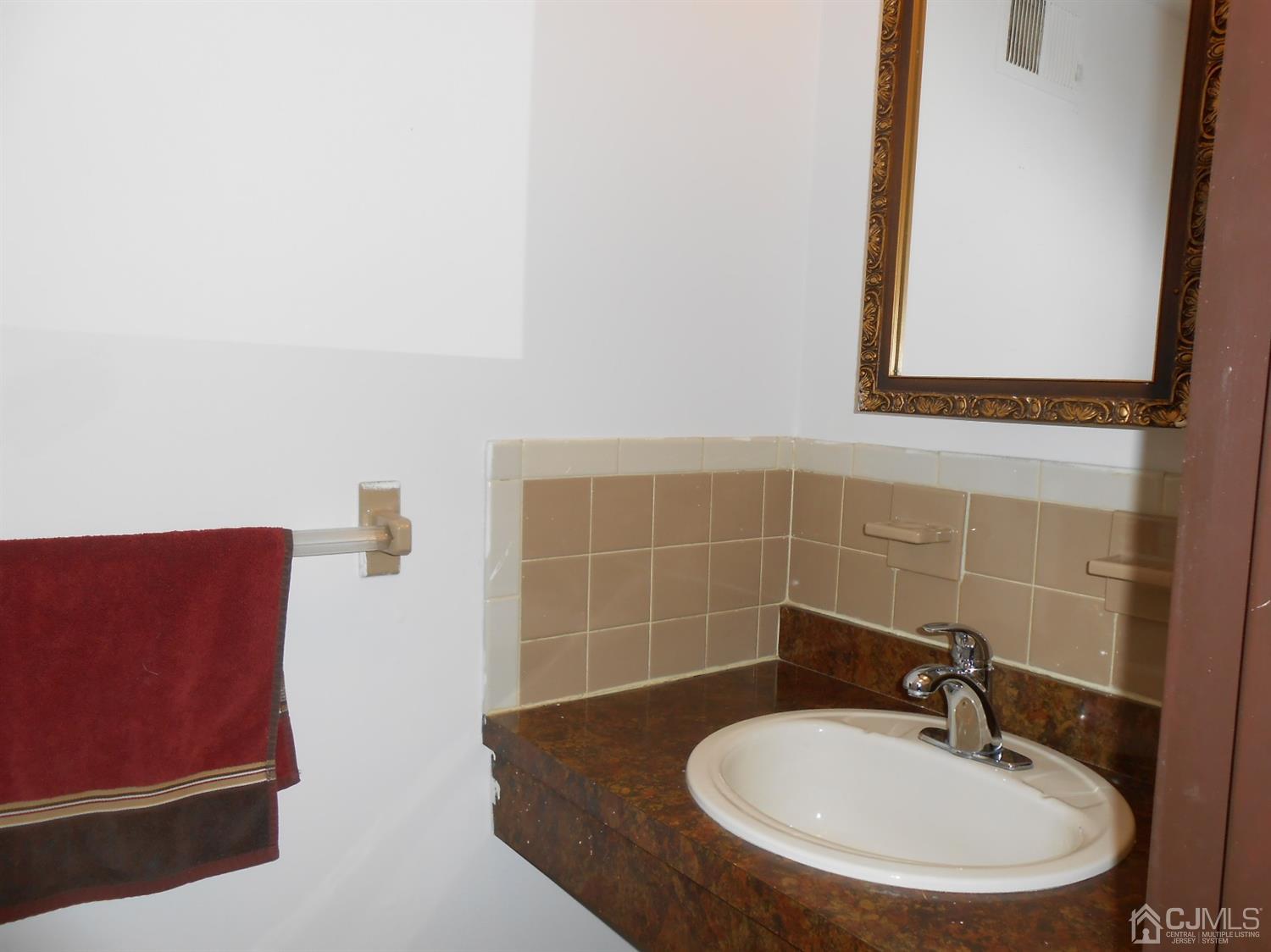 7206 Hana Road Edison, NJ 08817 - Photo 20 of 26 a bathroom with a sink and a mirror