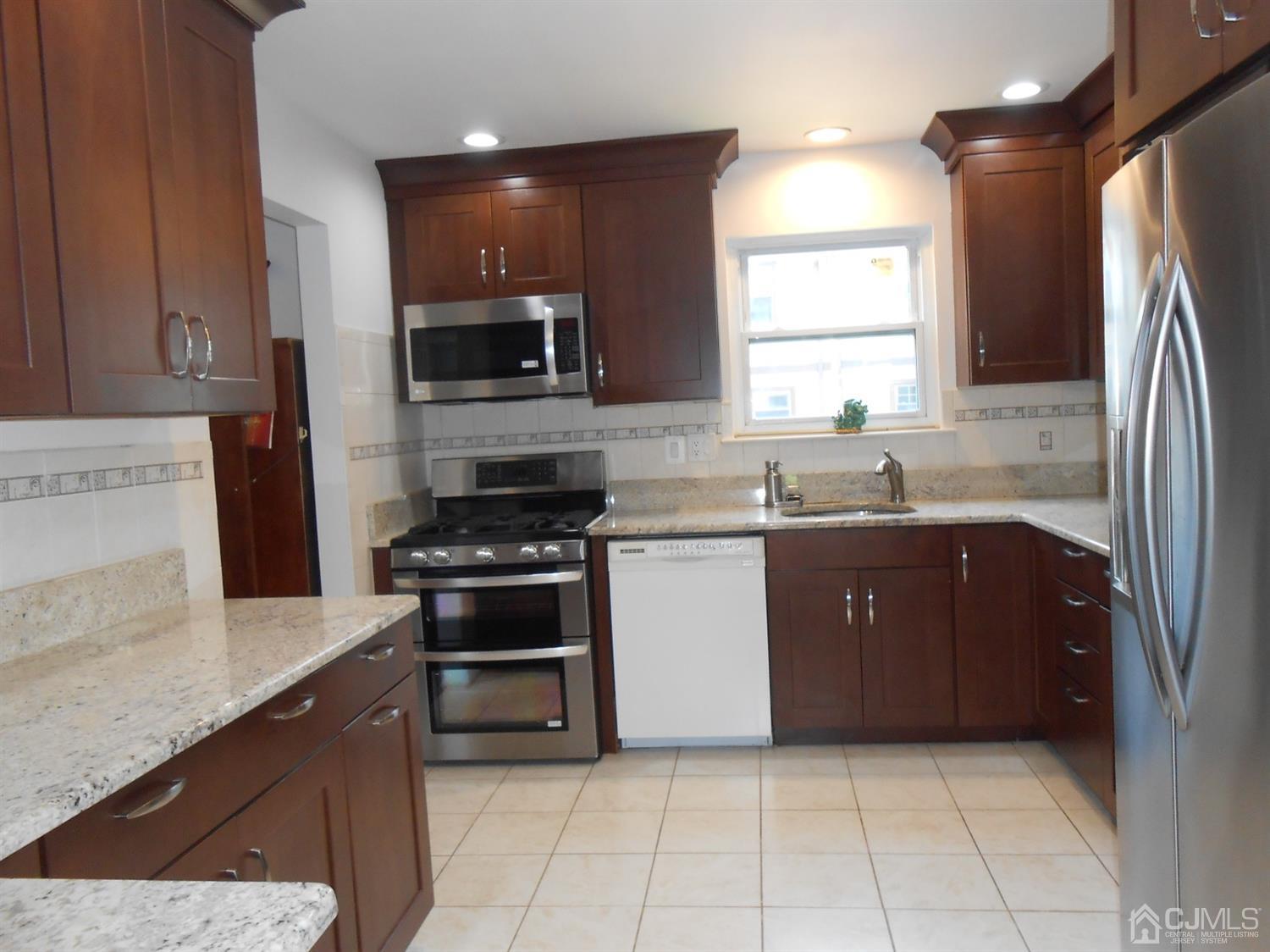 7206 Hana Road Edison, NJ 08817 - Photo 4 of 26 a kitchen with a sink stove and refrigerator