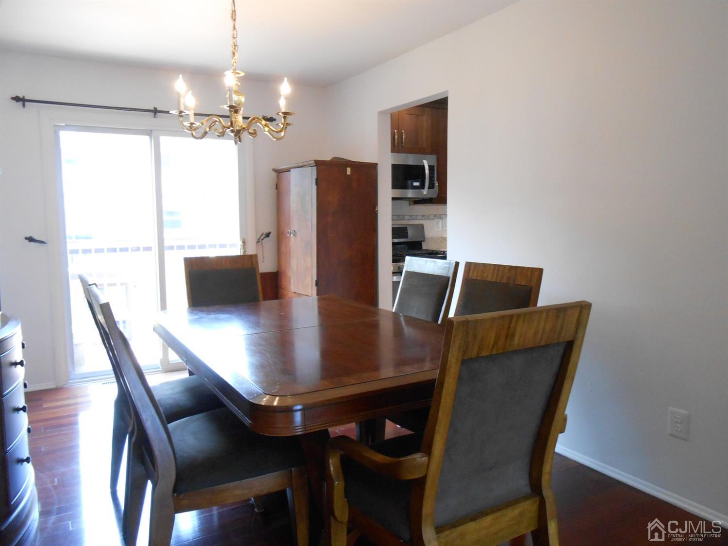 7206 Hana Road Edison, NJ 08817 - Photo 9 of 26 a view of a dining room with furniture and wooden floor