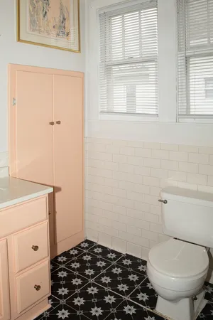 a bathroom with a toilet and a window