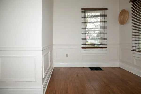 a view of a room with wooden floor and windows