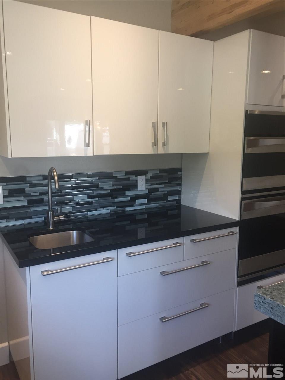 259 West Arroyo Street Reno, NV 89509 - Photo 12 of 24 a kitchen with granite countertop a sink and a stove
