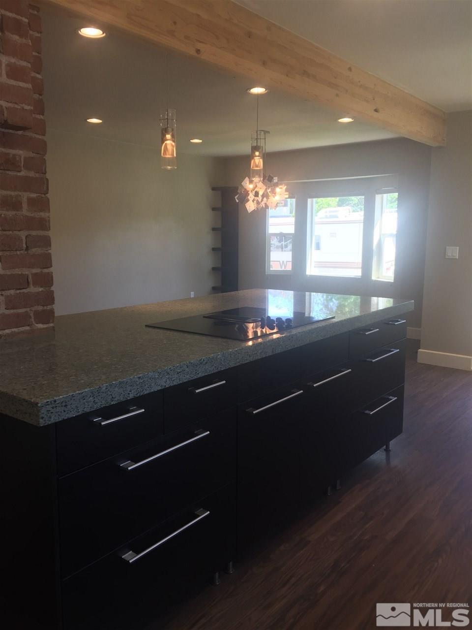 259 West Arroyo Street Reno, NV 89509 - Photo 14 of 24 a kitchen with kitchen island granite countertop a sink appliances and cabinets
