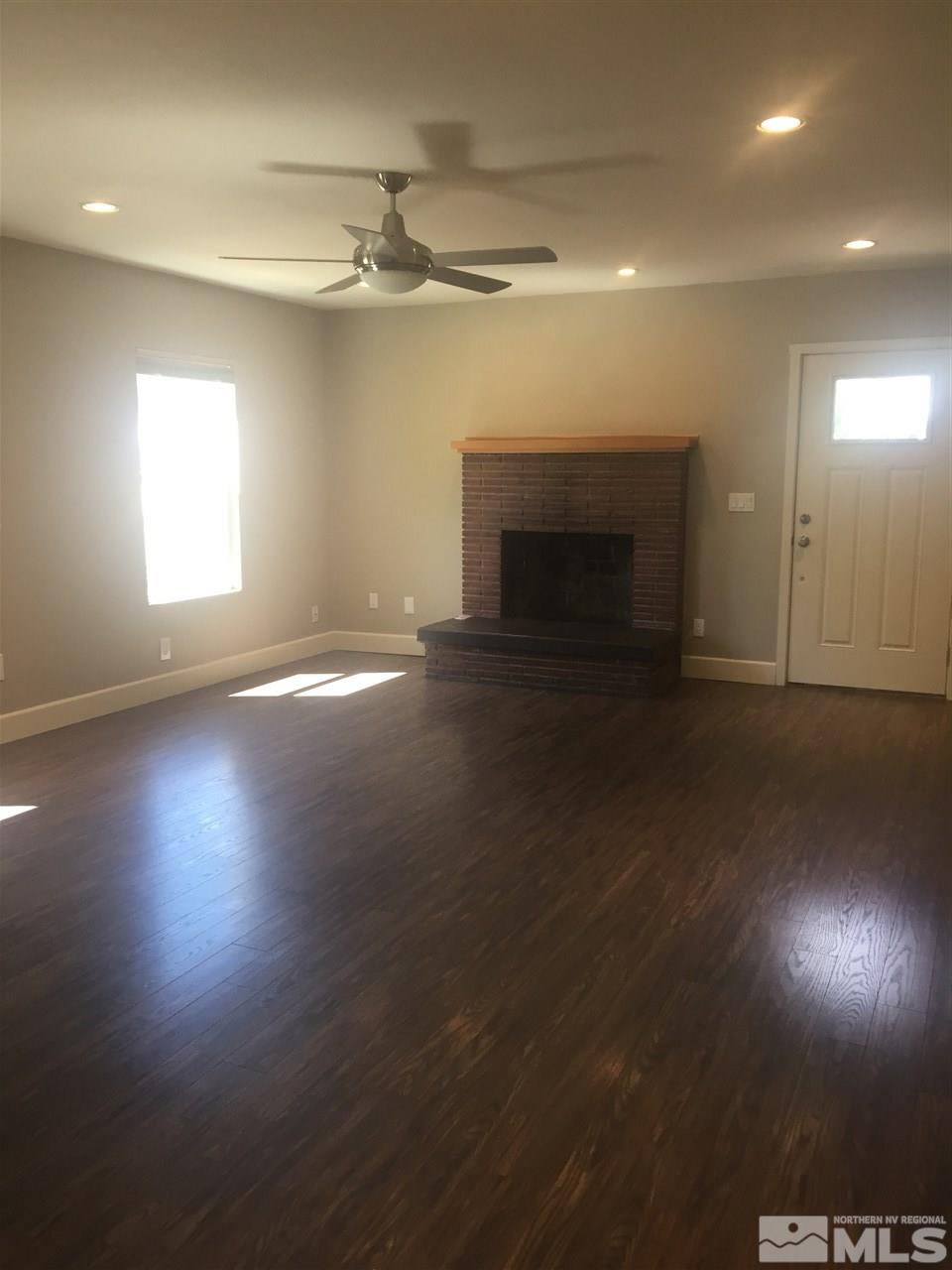 259 West Arroyo Street Reno, NV 89509 - Photo 15 of 24 an empty room with wooden floor fireplace and windows