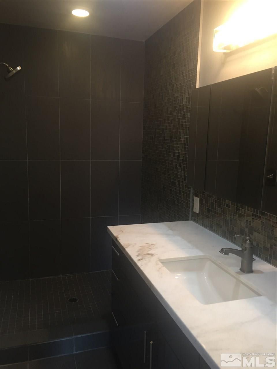 259 West Arroyo Street Reno, NV 89509 - Photo 18 of 24 a bathroom with a sink and a mirror