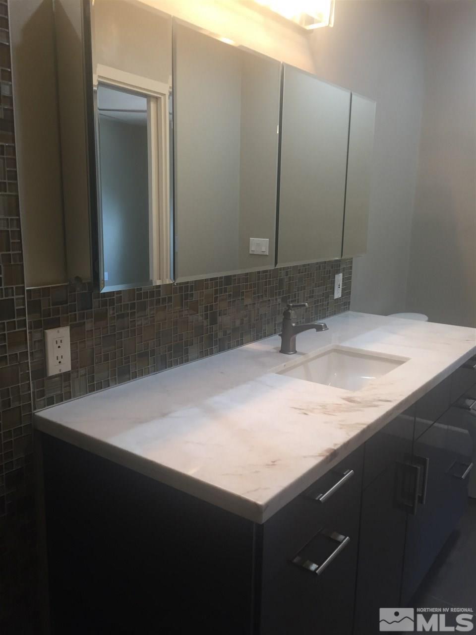 259 West Arroyo Street Reno, NV 89509 - Photo 19 of 24 a bathroom with a sink vanity and a mirror