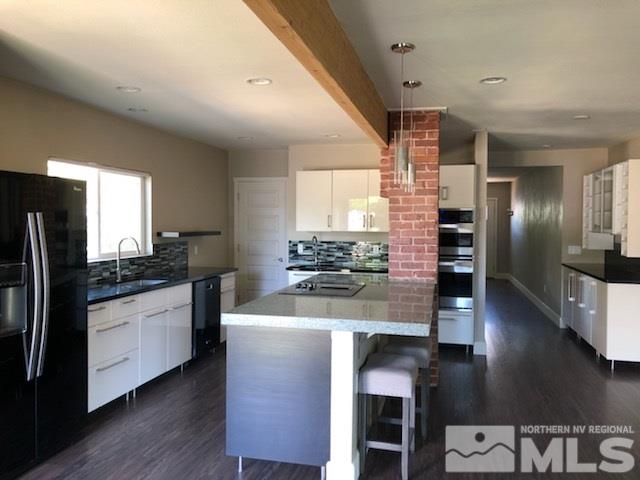 259 West Arroyo Street Reno, NV 89509 - Photo 4 of 24 a kitchen with stainless steel appliances granite countertop a refrigerator a stove and a wooden floors